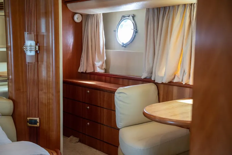 Richmind Yacht Photos Pics Luxurious interior of 2007 Azimut 68E yacht with wood finish and porthole window.