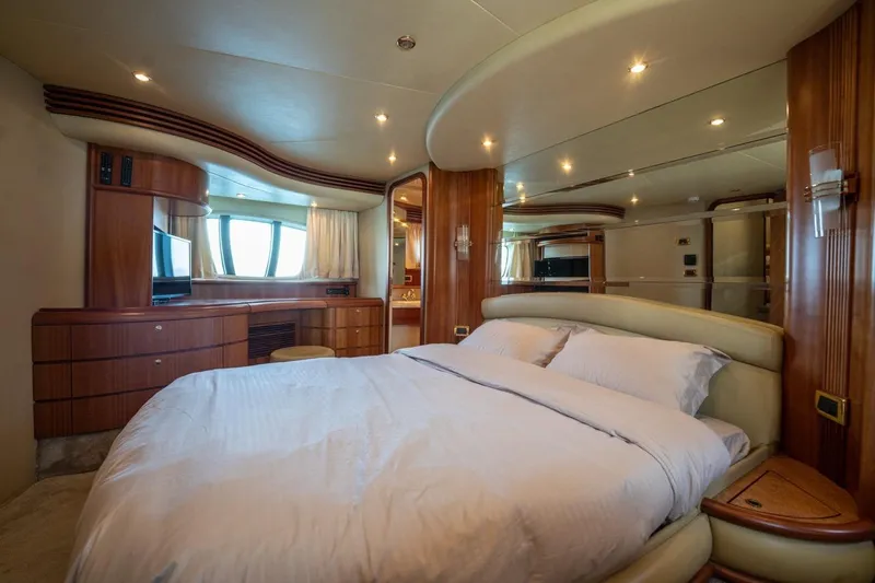 Richmind Yacht Photos Pics Luxurious bedroom interior of 2007 Azimut 68E yacht with elegant wood finishes.
