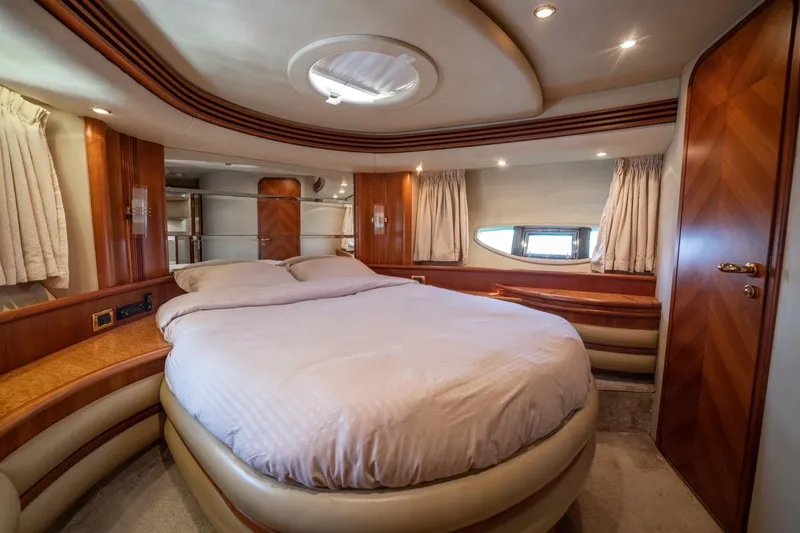 Richmind Yacht Photos Pics Luxurious bedroom interior of 2007 Azimut 68E yacht with elegant wood finishes.