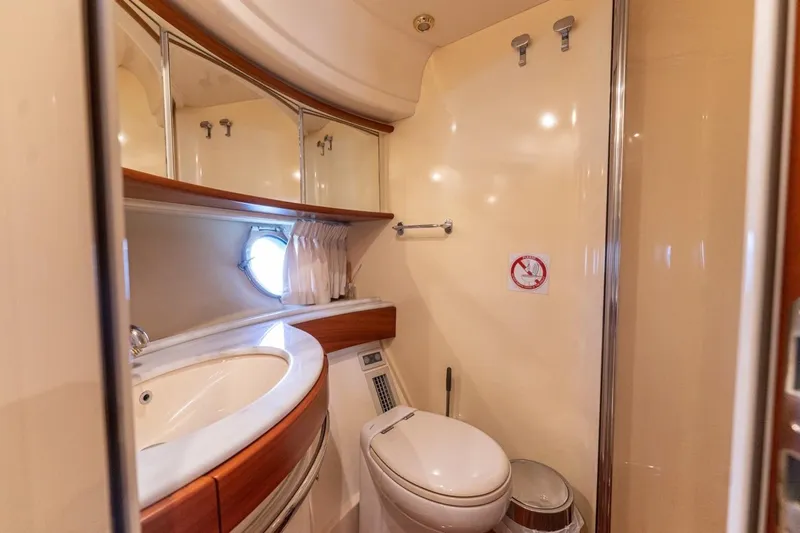 Richmind Yacht Photos Pics Luxurious bathroom in 2007 Azimut 68E yacht with modern fixtures and porthole window.