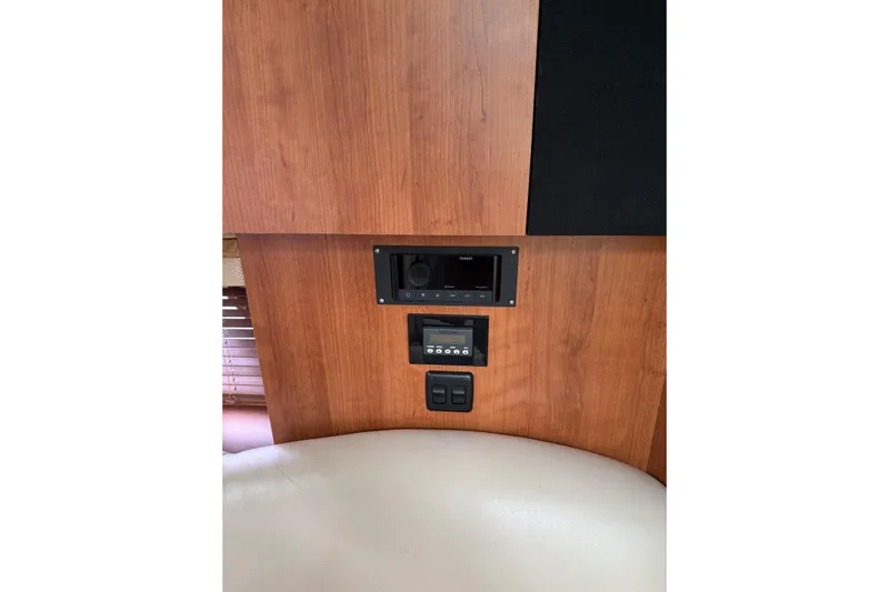  Yacht Photos Pics 2008 Cruisers Yachts 330 Express interior with wood paneling and control panel.