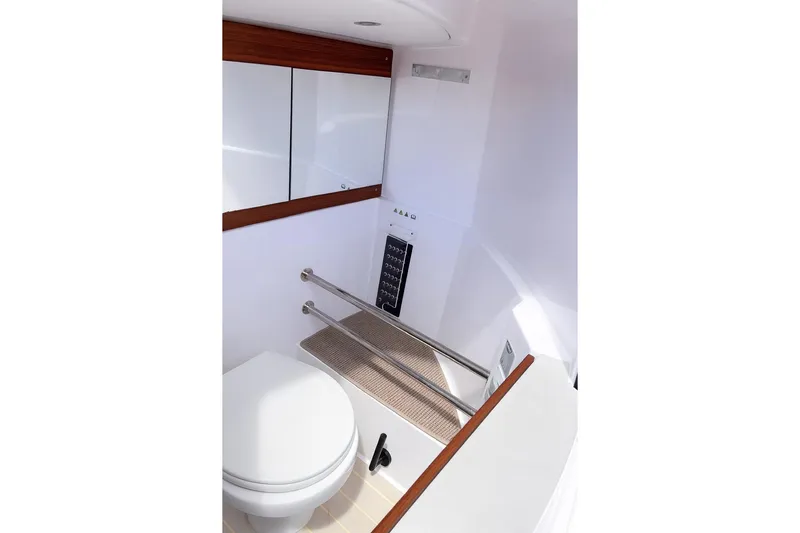  Yacht Photos Pics 2024 Axopar 28TT boat bathroom with modern fixtures and sleek design.