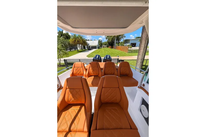  Yacht Photos Pics 2024 Axopar 28TT boat interior with luxurious orange seating and modern design.