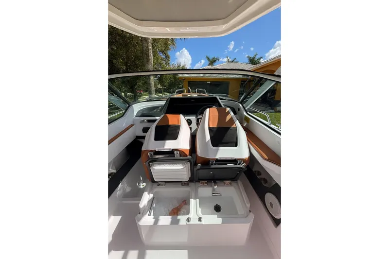  Yacht Photos Pics 2024 Axopar 28TT boat interior with modern seating and storage compartments.