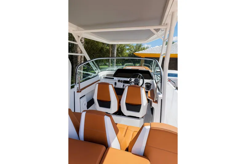  Yacht Photos Pics 2024 Axopar 28TT boat interior with orange seats and modern dashboard design.