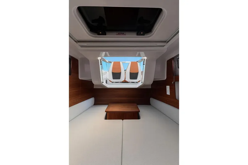  Yacht Photos Pics 2024 Axopar 28TT cabin interior with wood accents and skylight.