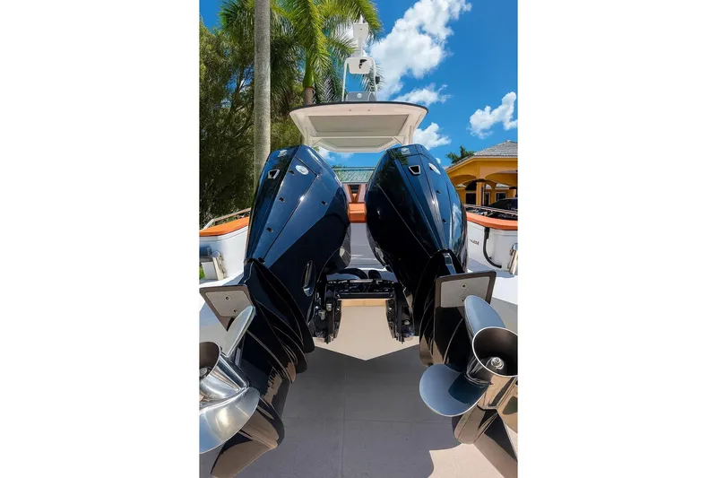  Yacht Photos Pics 2024 Axopar 28TT boat with dual outboard engines, set against a tropical backdrop.