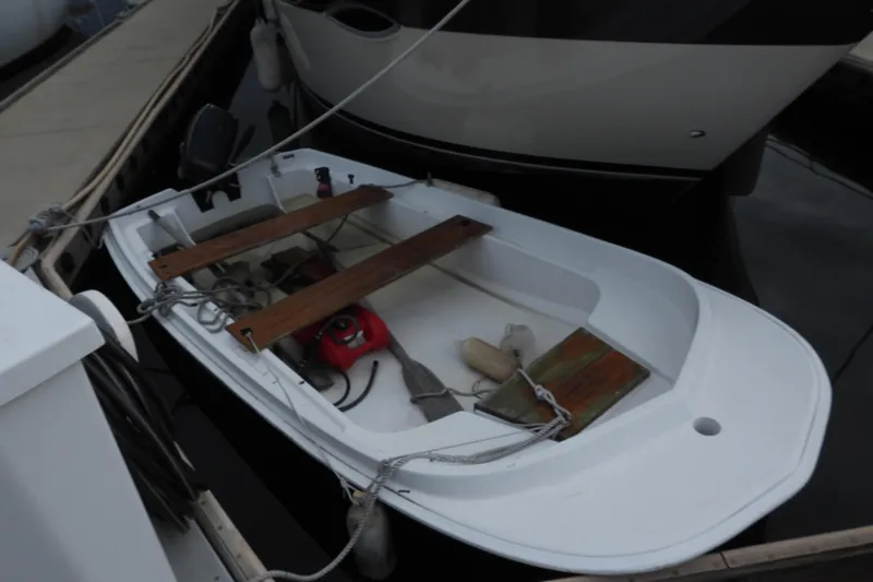  Yacht Photos Pics Small white dinghy docked beside a 2008 Carver 41 Cockpit Motor Yacht.