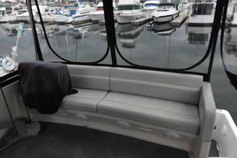  Yacht Photos Pics 2008 Carver 41 Cockpit Motor Yacht interior with marina view, featuring a cushioned seating area.