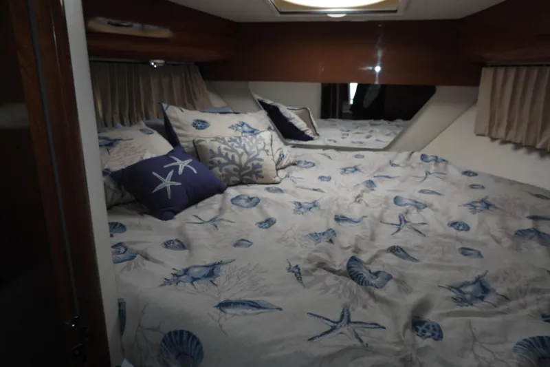  Yacht Photos Pics Cozy bedroom in 2008 Carver 41 Cockpit Motor Yacht with nautical-themed bedding.