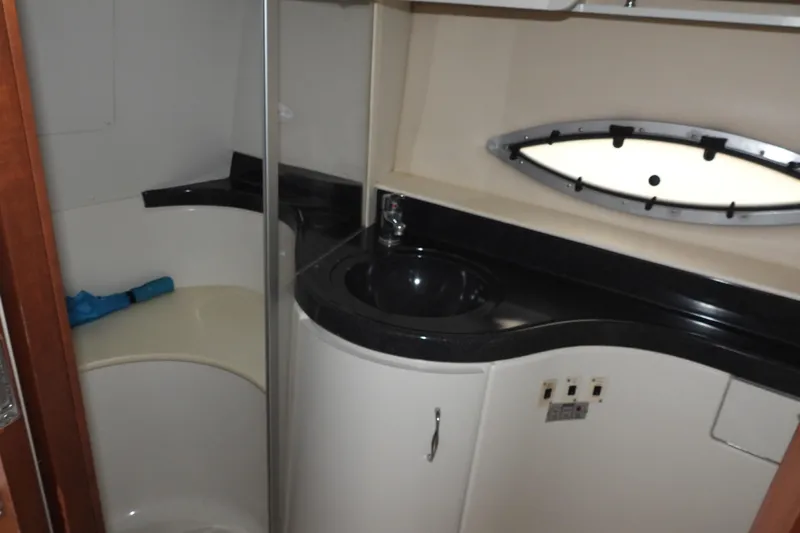  Yacht Photos Pics 2008 Carver 41 Cockpit Motor Yacht bathroom with sink, shower, and oval window.