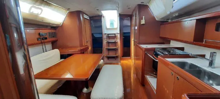 Latika Yacht Photos Pics Interior of 2011 Beneteau Oceanis 43 yacht with dining area and kitchen.