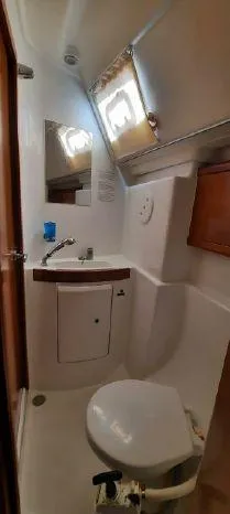 Latika Yacht Photos Pics 2011 Beneteau Oceanis 43 yacht bathroom with sink, mirror, and toilet.