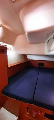 Latika Yacht Photos Pics Interior cabin of 2011 Beneteau Oceanis 43 sailboat with blue bedding.