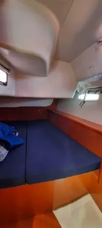 Latika Yacht Photos Pics Cabin interior of 2011 Beneteau Oceanis 43 sailboat with blue bedding.
