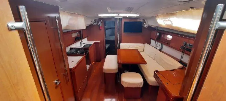 Latika Yacht Photos Pics Interior of 2011 Beneteau Oceanis 43 yacht with wood finish and cozy seating area.