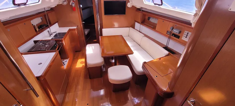 Latika Yacht Photos Pics 2011 Beneteau Oceanis 43 interior with dining area, kitchen, and seating.