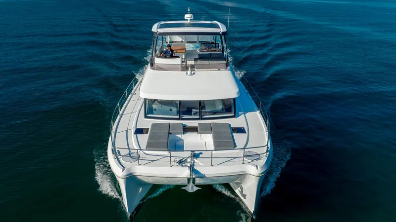 Au Natural Yacht Photos Pics 2023 Fountaine Pajot MY 6 yacht cruising on open water.