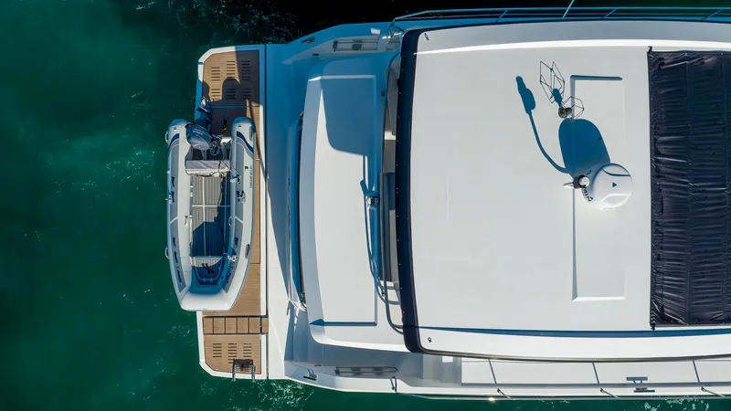 Au Natural Yacht Photos Pics Aerial view of 2023 Fountaine Pajot MY 6 yacht with tender on deck.