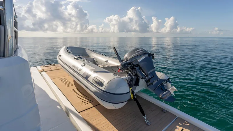 Au Natural Yacht Photos Pics Fountaine Pajot MY 6 yacht with inflatable boat on deck, 2023 model, ocean view.