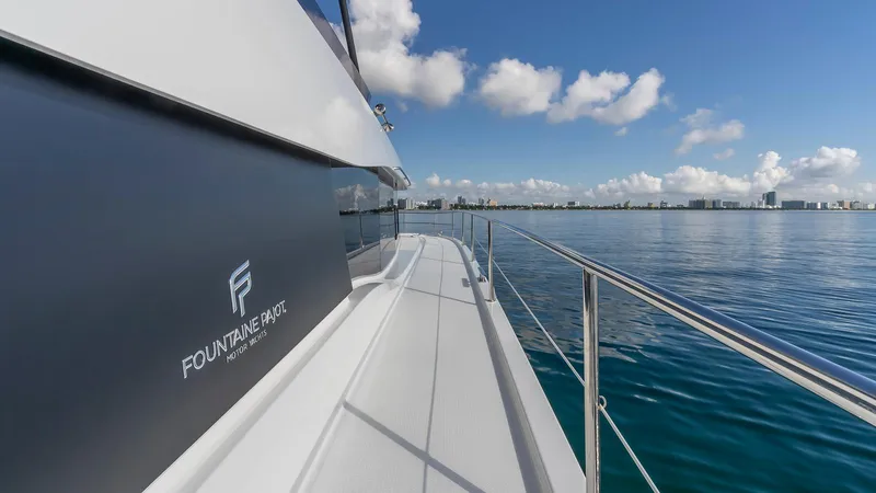 Au Natural Yacht Photos Pics 2023 Fountaine Pajot MY 6 yacht on calm waters under a clear blue sky.