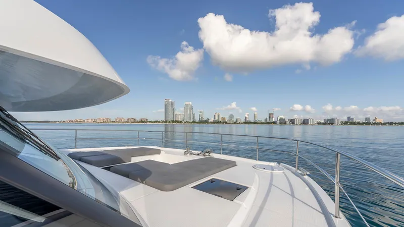 Au Natural Yacht Photos Pics 2023 Fountaine Pajot MY 6 yacht with city skyline and blue sky backdrop.