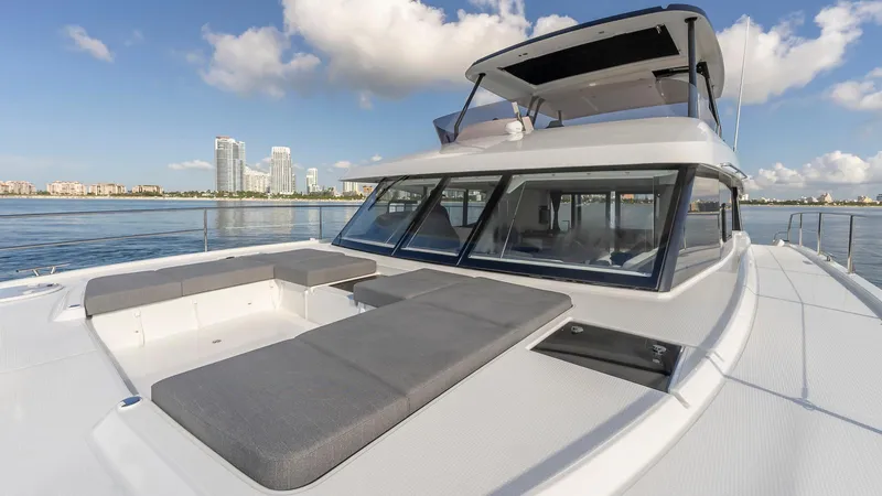 Au Natural Yacht Photos Pics 2023 Fountaine Pajot MY 6 yacht with city skyline in background.