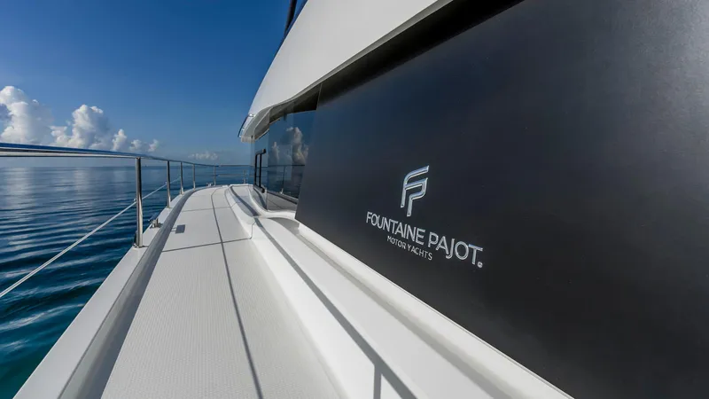 Au Natural Yacht Photos Pics Fountaine Pajot MY 6 yacht, 2023 model, cruising on calm blue waters.