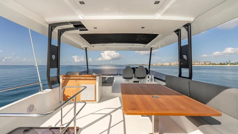 Au Natural Yacht Photos Pics 2023 Fountaine Pajot MY 6 yacht interior with ocean view, featuring sleek design and spacious seating.