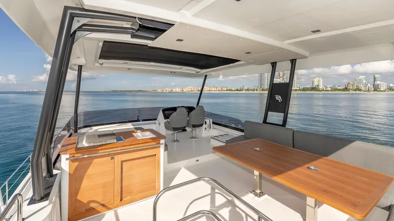 Au Natural Yacht Photos Pics Luxurious 2023 Fountaine Pajot MY 6 yacht interior with ocean view and modern seating area.