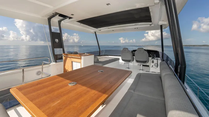 Au Natural Yacht Photos Pics Luxurious 2023 Fountaine Pajot MY 6 yacht interior with ocean view and modern seating.