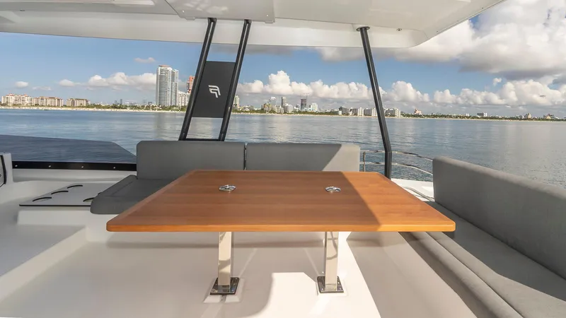 Au Natural Yacht Photos Pics Fountaine Pajot MY 6 yacht deck with table, ocean view, 2023 model.