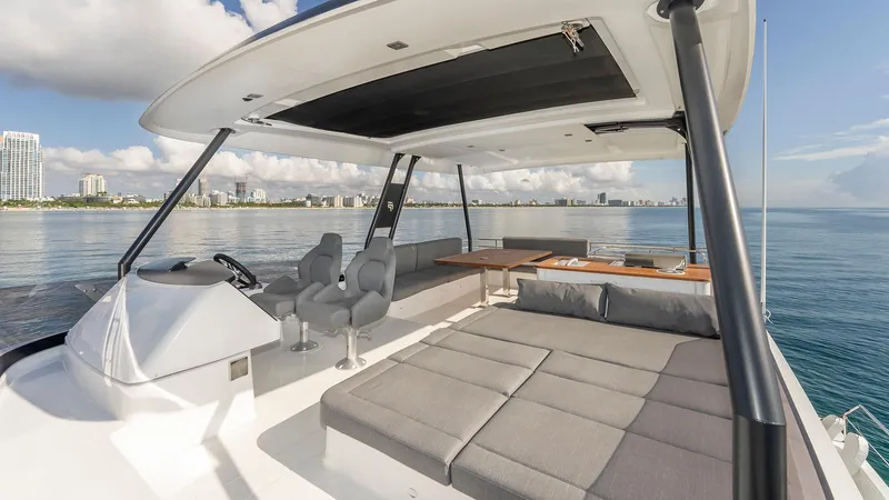 Au Natural Yacht Photos Pics Luxurious 2023 Fountaine Pajot MY 6 yacht with spacious deck and seating area.