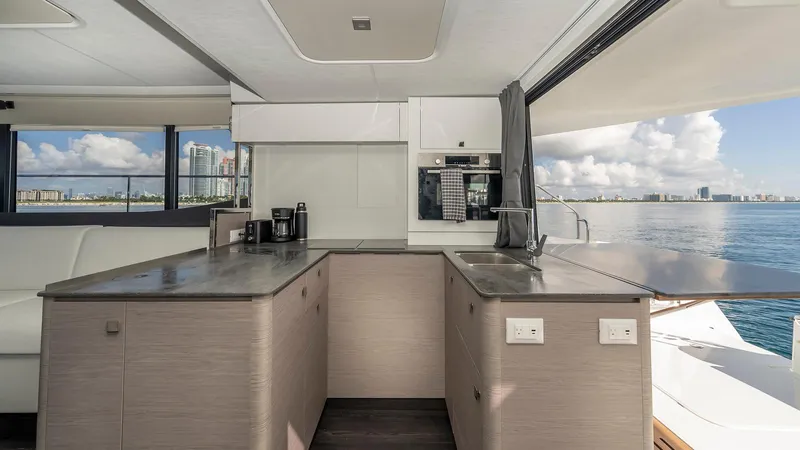 Au Natural Yacht Photos Pics Modern kitchen interior on 2023 Fountaine Pajot MY 6 yacht with ocean view.