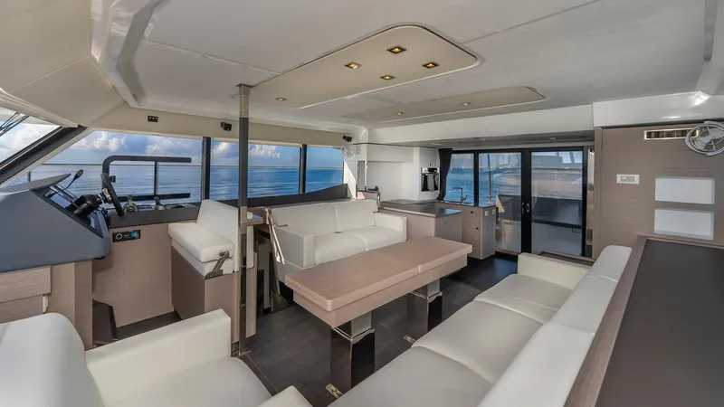 Au Natural Yacht Photos Pics Luxurious interior of 2023 Fountaine Pajot MY 6 yacht with modern seating and ocean view.