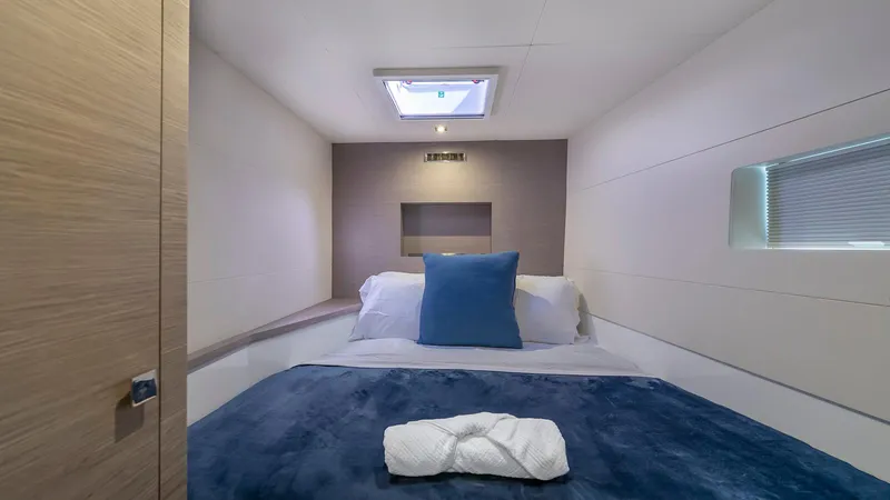 Au Natural Yacht Photos Pics Luxurious cabin interior of 2023 Fountaine Pajot MY 6 yacht with cozy bedding.