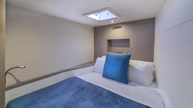 Au Natural Yacht Photos Pics Cozy bedroom in 2023 Fountaine Pajot MY 6 yacht with skylight and blue accents.