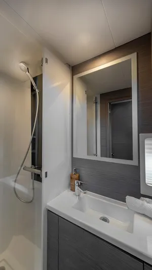 Au Natural Yacht Photos Pics Modern bathroom in 2023 Fountaine Pajot MY 6 yacht with sleek fixtures and mirror.