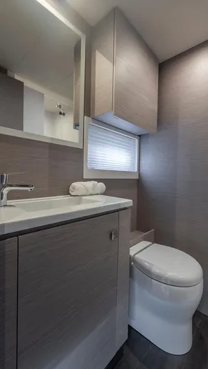 Au Natural Yacht Photos Pics Modern bathroom in 2023 Fountaine Pajot MY 6 yacht with sleek fixtures and wood accents.