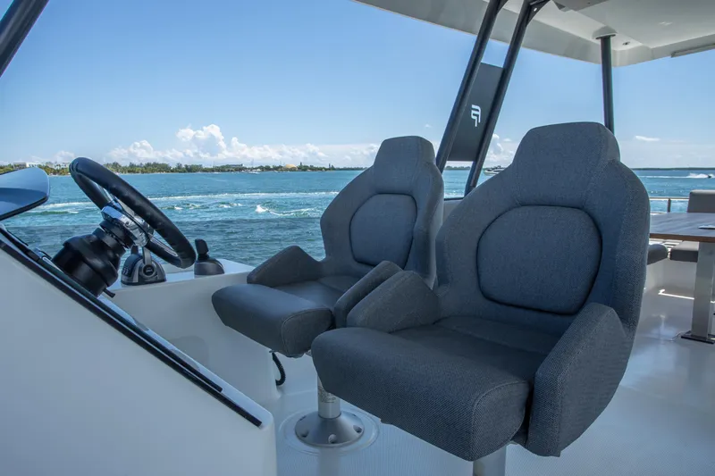 Au Natural Yacht Photos Pics 2023 Fountaine Pajot MY 6 yacht helm with dual seats and ocean view.
