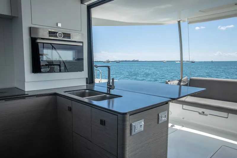 Au Natural Yacht Photos Pics Modern kitchen on 2023 Fountaine Pajot MY 6 yacht with ocean view.