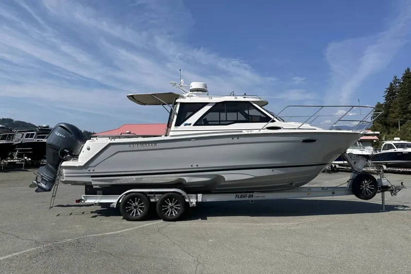  Yacht Photos Pics 2026 Cutwater C-248 Coupe boat on trailer under clear blue sky.