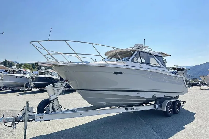  Yacht Photos Pics 2026 Cutwater C-248 Coupe boat on trailer in sunny marina setting.