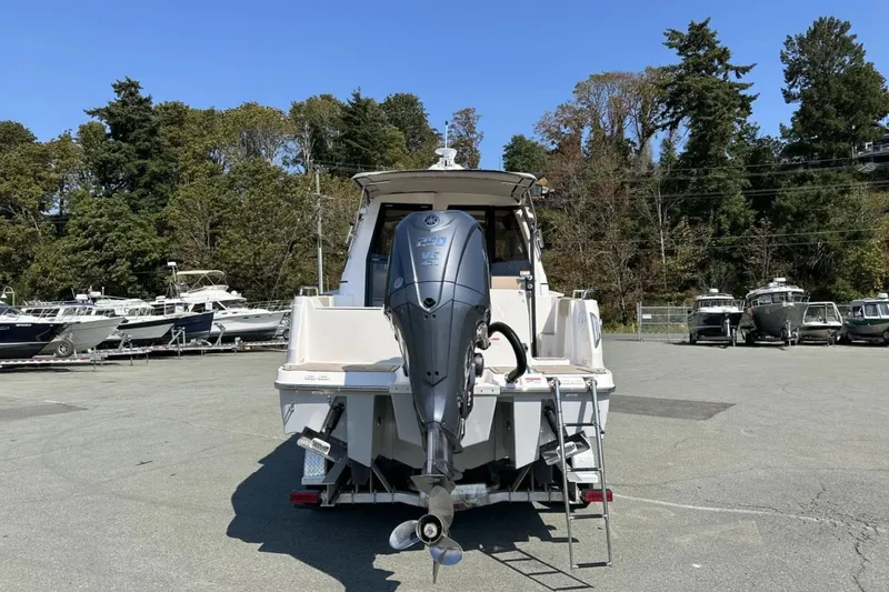  Yacht Photos Pics 2026 Cutwater C-248 Coupe boat with outboard motor, parked in a marina.