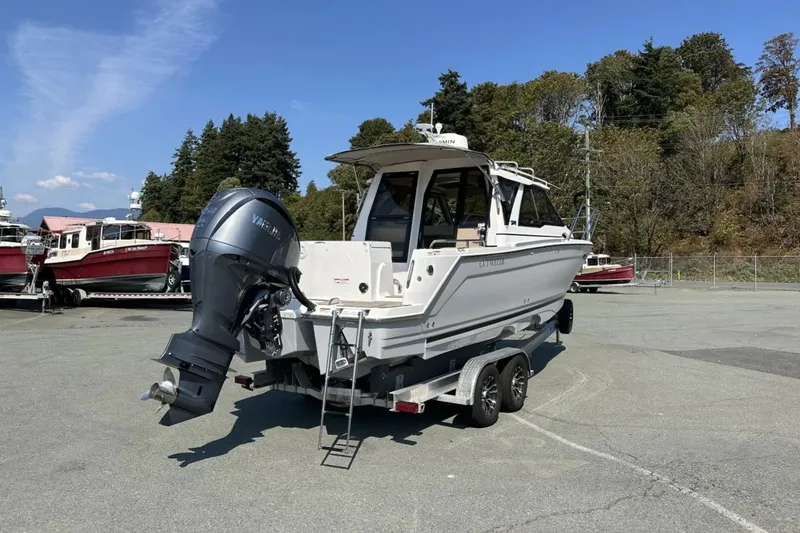  Yacht Photos Pics 2026 Cutwater C-248 Coupe boat on trailer, parked outdoors under clear sky.