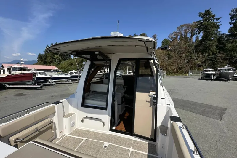  Yacht Photos Pics 2026 Cutwater C-248 Coupe boat docked, showcasing rear deck and cabin entrance.