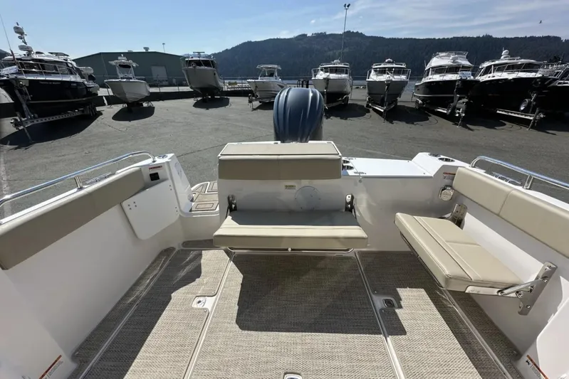  Yacht Photos Pics 2026 Cutwater C-248 Coupe boat interior with seating, docked among other boats.