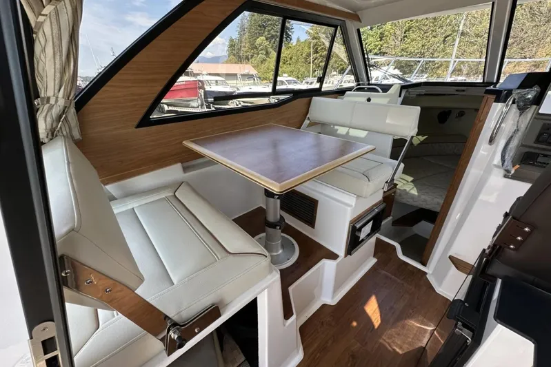  Yacht Photos Pics 2026 Cutwater C-248 Coupe interior with modern seating and table, featuring wood accents.
