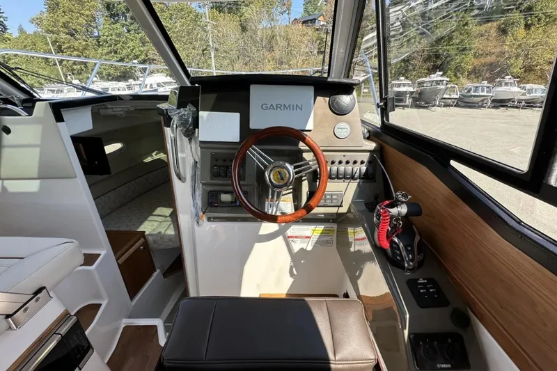  Yacht Photos Pics 2026 Cutwater C-248 Coupe helm with Garmin navigation, featuring modern controls and wood accents.