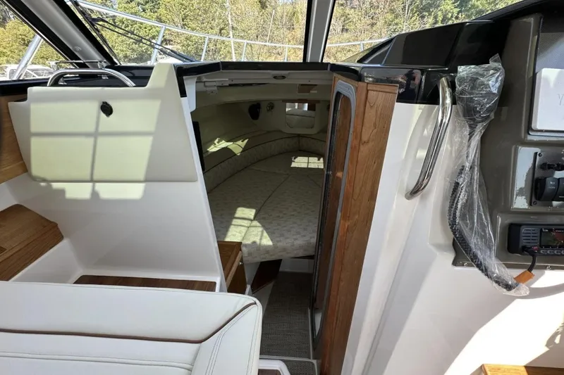  Yacht Photos Pics Interior view of 2026 Cutwater C-248 Coupe cabin with bed and wooden accents.